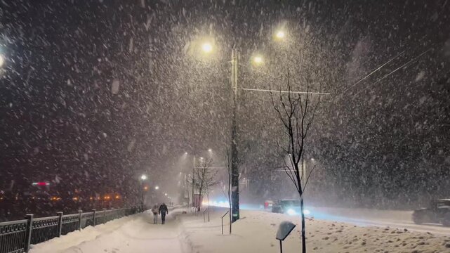A snowstorm and snowfall on the evening streets of the city. The city is buried in snow. Ternopil, Ukraine, 