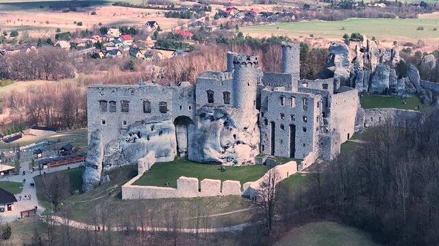 Aerial Poland Zamek Ogrodzieniec mountain castle slide. Ruins of medieval castle south Poland. Original stronghold from 11th century, stone castle built in13th century. Rocky mountain top.