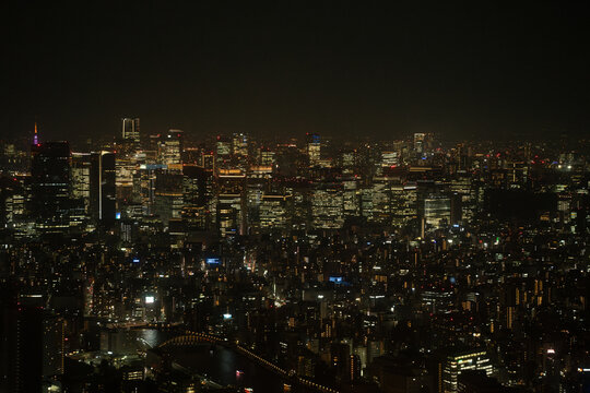 Tokyo urban night view with glowing city lights and river