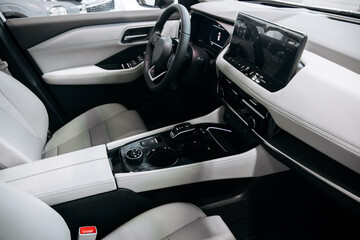 Fototapeta premium Modern automotive interior featuring a smart driving interface, leather seats, and a sleek dashboard design with a large touchscreen display and central console
