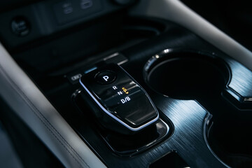 Obraz premium Close up of car center console with gear shift and touchscreen controls. Automotive technology concept. 