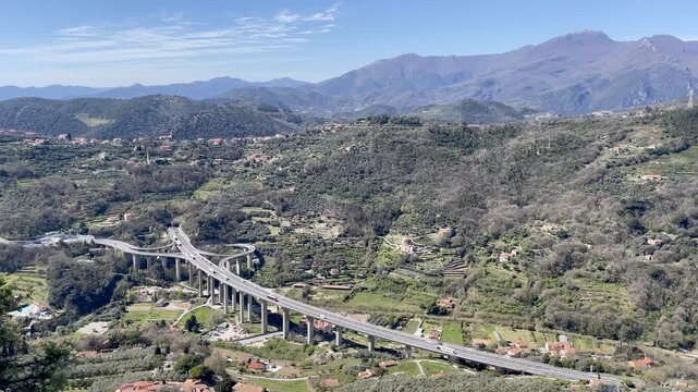 Autostrada A10 winding along the Ligurian coast, passing through stunning Mediterranean landscapes with cliffs, turquoise sea, and picturesque coastal scenery.