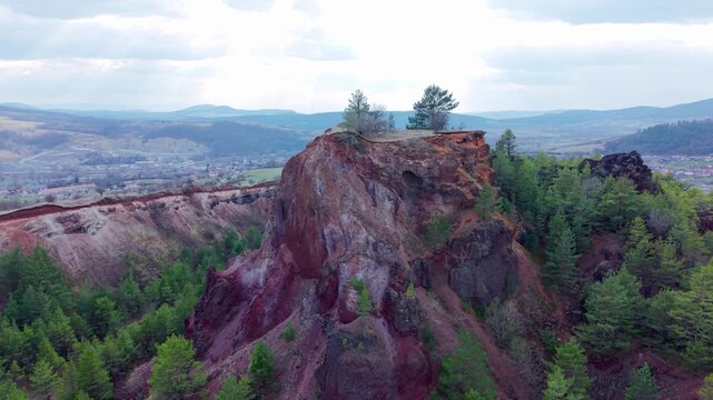 Aerial orbit of Racoș volcanic crater cliff