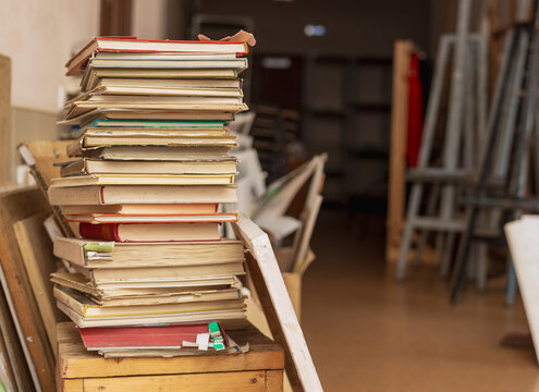 A stack of old books in an art studio. 