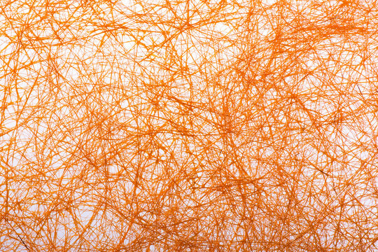 Orange fibrous handmade paper texture background. Abstract messy silk fiber mesh surface for vibrant autumn aesthetic craft design