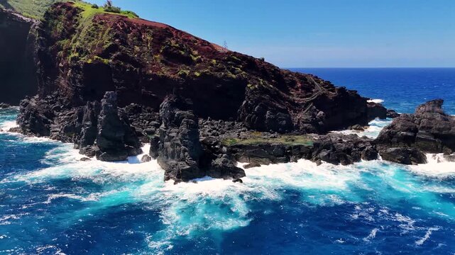 Majestic aerial view of the remote Pitcairn Islands in the South Pacific, featuring lush green volcanic cliffs and deep blue ocean waves. Pitcairn island, British Overseas Territory. 4K drone footage
