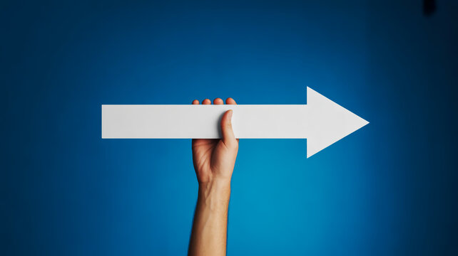 A hand holding a white arrow pointing to the right