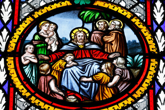  Stained glass roundel depicting the biblical scene of Jesus welcoming little children among his apostles. Albertville. France.