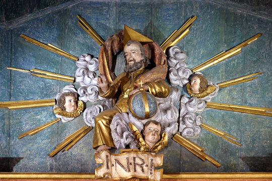 Saint Maurice church.   Baroque altarpiece. 18th century. God the Father carrying the world in his hands.   Thones. France.