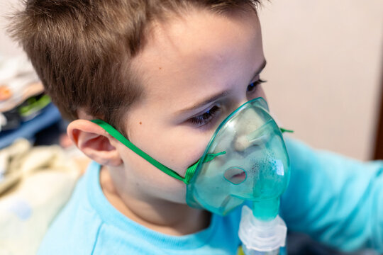 Little boy in an oxygen mask. A boy in a mask does inhalation to treat a lung disease
