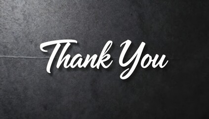 Obraz premium Elegant thank you message against a dark background with a slightly textured surface