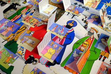 Fototapeta premium Layered paper pop-up spreads depicting the birth of Jesus with shepherds, kings, and animals.