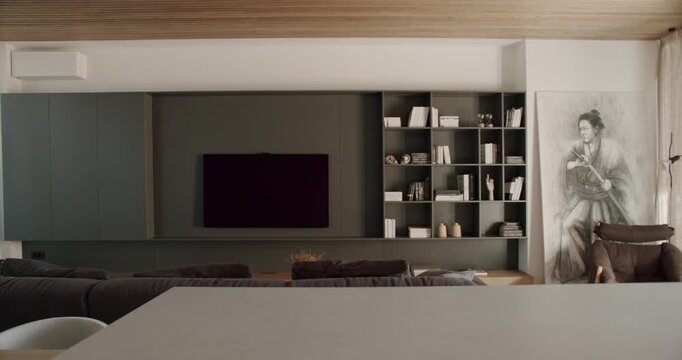 Modern Living Room Interior With TV and Bookshelves. Cozy and stylish living room with comfortable furniture and a large TV screen. Perfect for relaxation and entertainment.