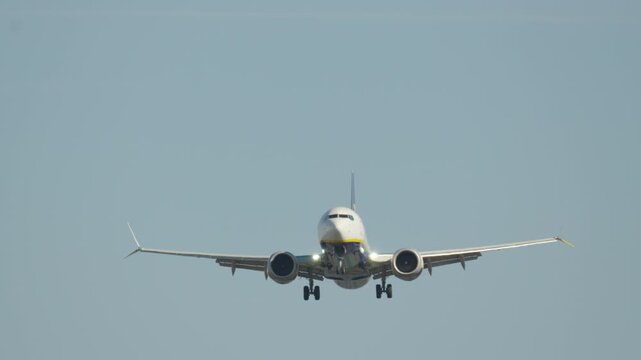Airplane landing approach at busy airport with clear skies and passengers eager for arrival
