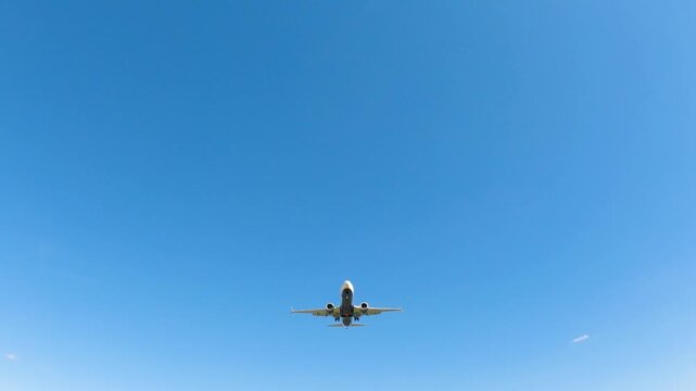 Aircraft landing approach over runway with clear skies capturing travel excitement and timely arrivals