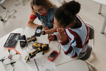 High school students working on robotics project. Girls in STEM.
