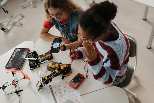 High school students working on robotics project. Girls in STEM.