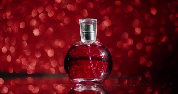 A striking red perfume bottle with a transparent cap displayed against a glamorous red bokeh background, evoking feelings of luxury and sophistication. Elegant Red Perfume Bottle