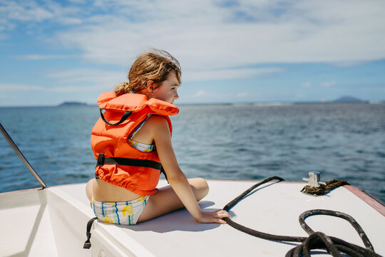Girl on boat during tropical family vacation.
