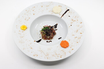  Asian kitchen. Gourmet beef tartare topped with crispy seaweed, mint leaf and sesame garnish. © Godong Photo