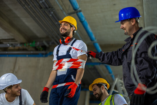 Workers Using Barrier Tape for a Practical Joke on Building Site