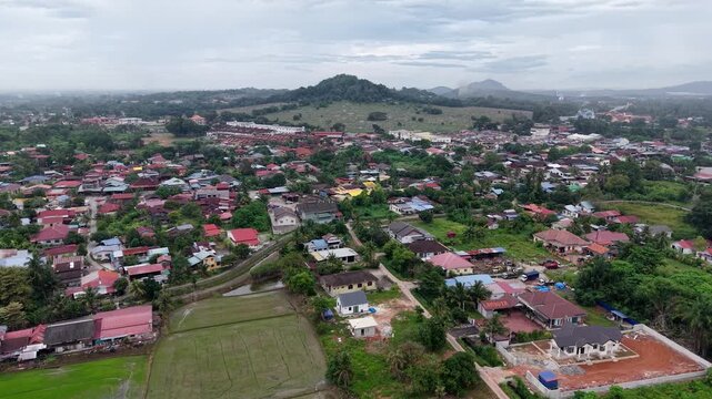Aerial drone view of Kubang Semang town and rice fields