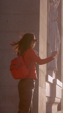 Happy female traveler dancing at sunset in Madrid Almudena Cathedral, spain