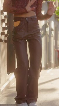 Unrecognizable Happy energetic young woman dancing on city street