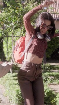 Happy young woman dancing in a beautiful garden