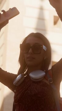 Happy young woman dancing in the city street