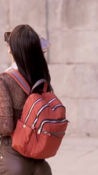 Joyful student woman dancing happily uphill on stairs