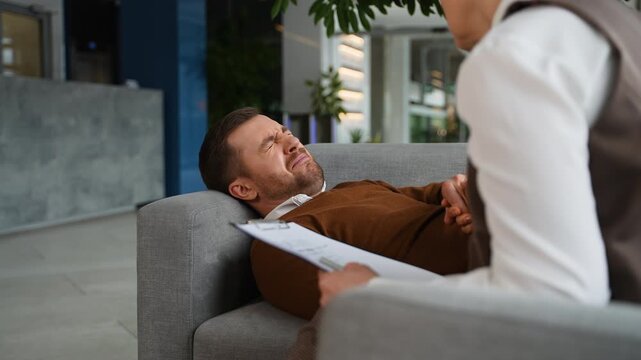 Man crying during therapy session with psychologist