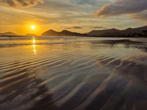 Incredible orange sunset on a paradisiacal beach.