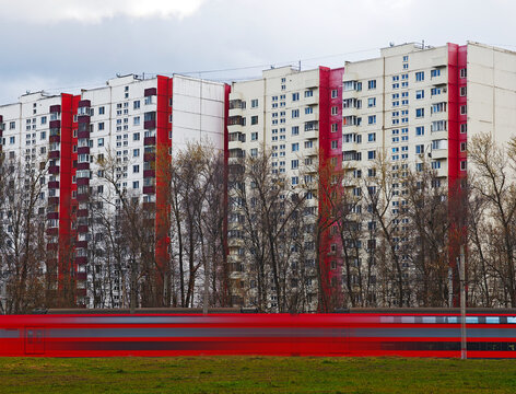 Red train carriages near red secondhand realty transportation backdrop