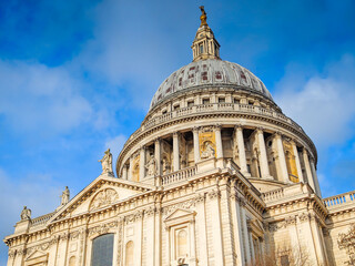 Obraz premium St Pauls Cathedral in London on a sunny day, iconic historic landmark with blue sky, famous British architecture and travel destination scene