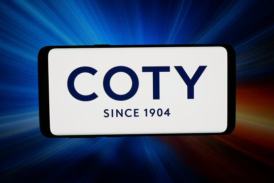 Stuttgart, Germany - 03-31-2026: In this photo illustration, the logo of beauty and cosmetics company Coty Inc. is displayed on a smartphone in front of abstract background on computer screen.