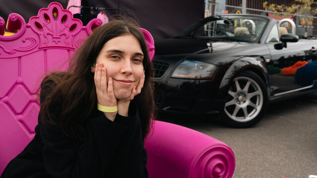 Close Portrait of Woman in Pink Armchair at KyivCarFest in Kyiv, Ukraine