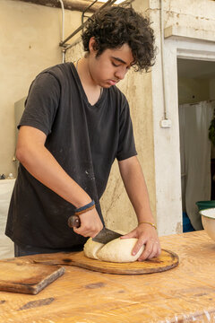 Boy separating balls of dough into pieces