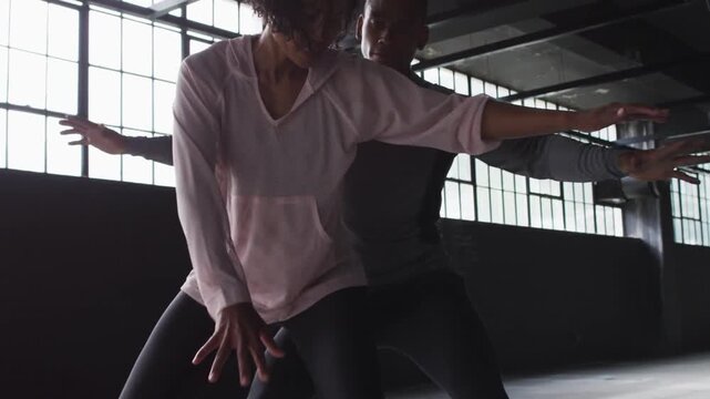 Woman running basketball drill in gym, VIBES overlays sliding, clearing, dribbling to protect ball