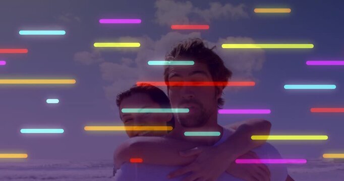 Man walking beach, woman coming from behind giving playful hug, moving bars covering couple travel