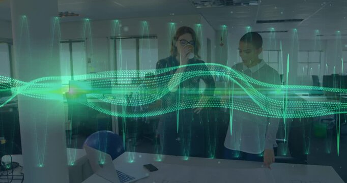 Two coworkers watching green AR waveform appearing, moving, highlighting laptop phone for analysis