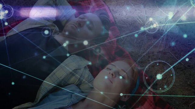 Couple lying on red plaid blanket after settling tech overlay sweeping, pulsing nodes showing links