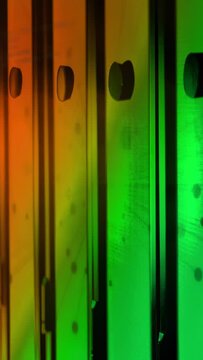 Vertical video: Cam shift starting glass panels sliding over orange green gradient, showing print