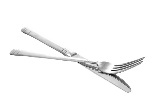 quality assortment of essential kitchen utensils including spatula, whisk, ladle, knives, neatly on a clean white surface, highlighting modern cooking tools and culinary preparation