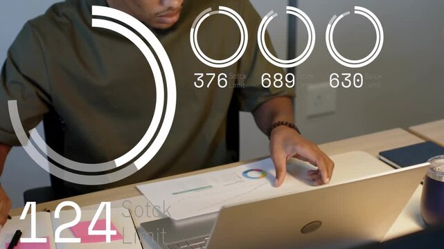 Analyst writing pink notes, moving hand to laptop, flipping charts while HUD overlays altering data