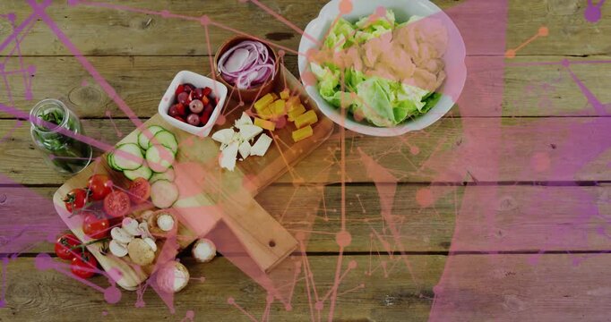Displaying prepared salad ingredients on wooden cutting boards at kitchen table, with pink overlay