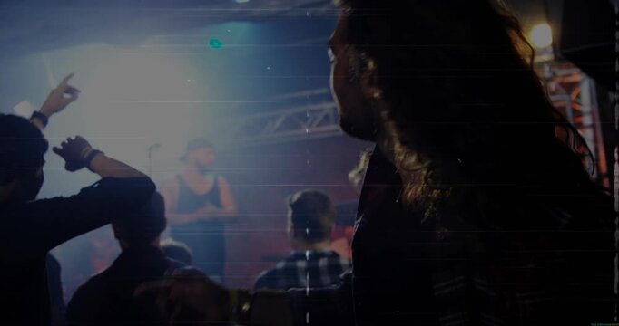 Long-haired fan headbanging as music starting crowd raising arms animated waves syncing with hair