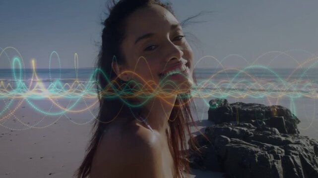 Woman turning toward camera after waveform pulsing, syncing mouth, laughing on beach for marketing