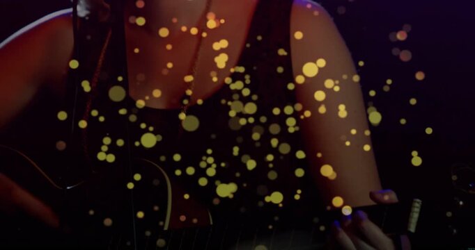 Vertical video: Playing guitarist tank guitar singing to mic onstage camera pulling back performing