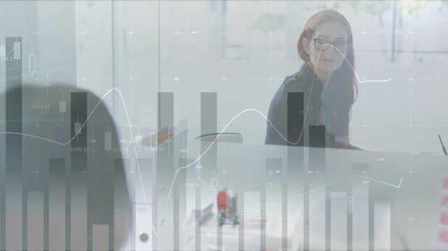 Peer speaking, woman in glasses turning, leaning, smiling as overlay showing data for review
